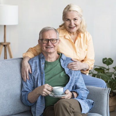 Senior Couple Smiling While Drinking Coffee